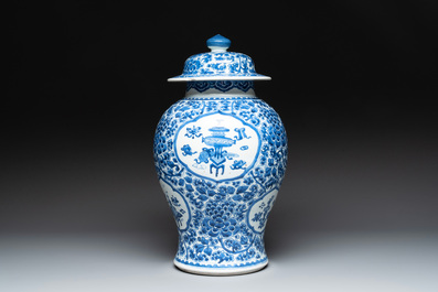A Chinese blue and white 'antiquities and peony scrolls' vase and cover, Kangxi