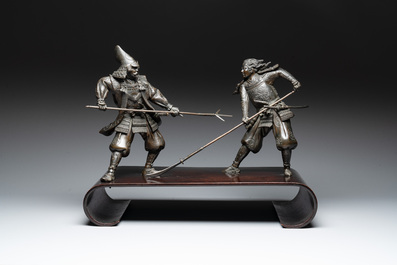 A fine pair of Japanese bronze warriors mounted on a wooden stand, Meiji/Taisho, 19/20th C.