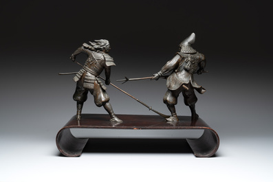 A fine pair of Japanese bronze warriors mounted on a wooden stand, Meiji/Taisho, 19/20th C.