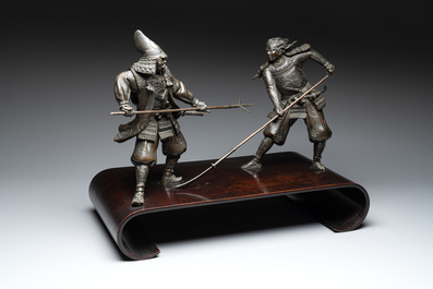 A fine pair of Japanese bronze warriors mounted on a wooden stand, Meiji/Taisho, 19/20th C.