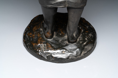 A Japanese bronze sculpture of a boy feeding a bird on a wooden stand, signed, Meiji, 19th C.