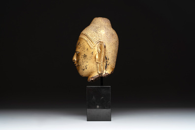 A Burmese gilt-lacquered bronze head of Buddha, 19th C.