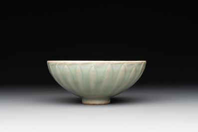 A Chinese Longquan celadon 'lotus' bowl and a large green-glazed jar, Ming and later