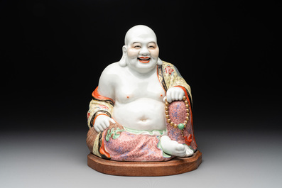 A large Chinese famille rose Milefo Buddha on wooden stand, 20th C.