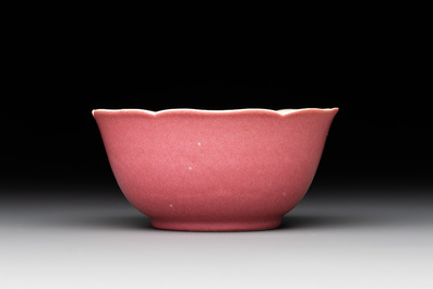 Three Chinese ruby-ground famille rose plates and a cup, 19th C.