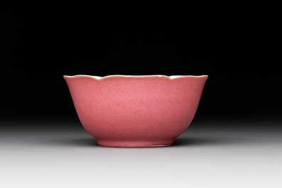 Three Chinese ruby-ground famille rose plates and a cup, 19th C.