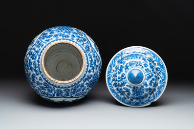 A Chinese blue and white 'antiquities and peony scrolls' vase and cover, Kangxi