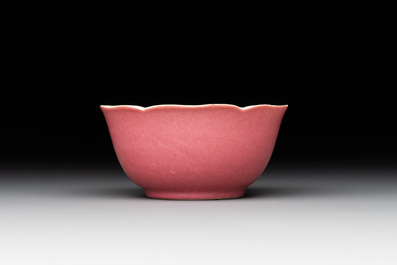 Three Chinese ruby-ground famille rose plates and a cup, 19th C.