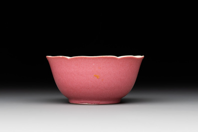 Three Chinese ruby-ground famille rose plates and a cup, 19th C.