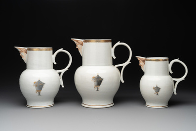 Three Chinese famille rose armorial 'face' ewers with the arms of Thomas Hankey, Qianlong