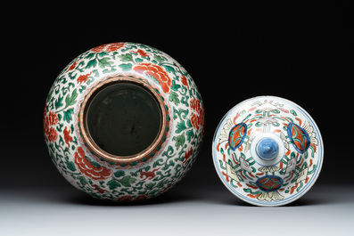 A Chinese wucai 'boy and peony scroll' vase and cover, 17th C.