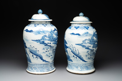 A near pair of Chinese blue and white 'landscape' vases and covers, 19th C.