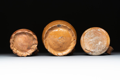 Eight stoneware jugs and mugs, and a glazed pottery vessel, Germany and The Netherlands, 16/17th C.