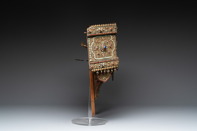A Nepalese gilt copper console inlaid with glass, precious stones and red coral, 19th C.