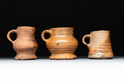 Eight stoneware jugs and mugs, and a glazed pottery vessel, Germany and The Netherlands, 16/17th C.