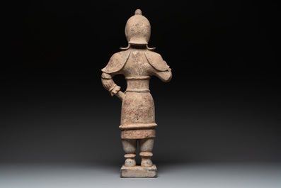A large Chinese painted pottery figure of a standing guardian, Tang