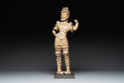 A Chinese stoneware cream-glazed sculpture of a warrior, possibly Tang