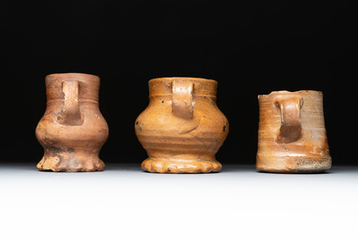 Eight stoneware jugs and mugs, and a glazed pottery vessel, Germany and The Netherlands, 16/17th C.