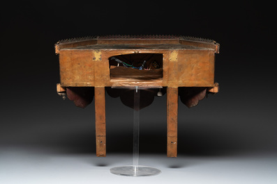 A Nepalese gilt copper console inlaid with glass, precious stones and red coral, 19th C.
