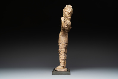 A Chinese stoneware cream-glazed sculpture of a warrior, possibly Tang