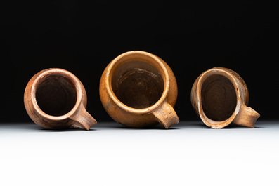 Eight stoneware jugs and mugs, and a glazed pottery vessel, Germany and The Netherlands, 16/17th C.