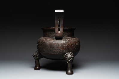 A large Chinese bronze archaistic 'taotie' tripod censer, 18th C.