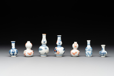 Seven Chinese iron-red, blue and white miniature vases, Kangxi