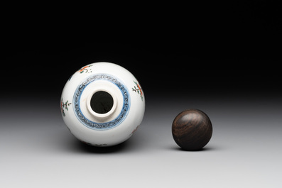 A Chinese famille verte ovoid tea caddy with floral design and a cup with figural design, Kangxi