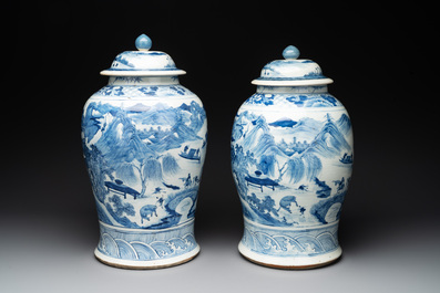 A near pair of Chinese blue and white 'landscape' vases and covers, 19th C.