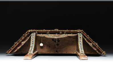A Nepalese gilt copper console inlaid with glass, precious stones and red coral, 19th C.