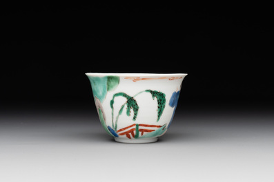 A Chinese famille verte ovoid tea caddy with floral design and a cup with figural design, Kangxi