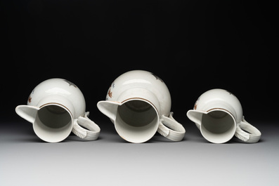 Three Chinese famille rose armorial 'face' ewers with the arms of Thomas Hankey, Qianlong