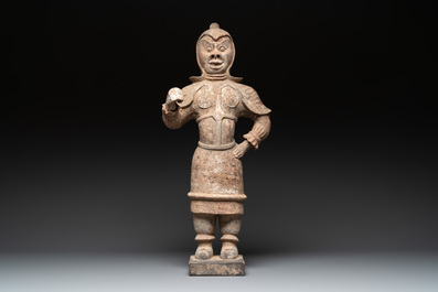 A large Chinese painted pottery figure of a standing guardian, Tang