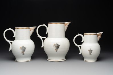 Three Chinese famille rose armorial 'face' ewers with the arms of Thomas Hankey, Qianlong