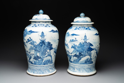 A near pair of Chinese blue and white 'landscape' vases and covers, 19th C.