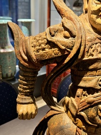 A large Chinese polychrome-lacquered wooden figure of a Guardian King, 18/19th C.