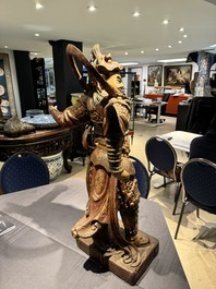 A large Chinese polychrome-lacquered wooden figure of a Guardian King, 18/19th C.