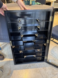 A Chinese gilt-lacquered wall display cabinet and a collection of various snuff bottles, stands and carvings, 20th C.