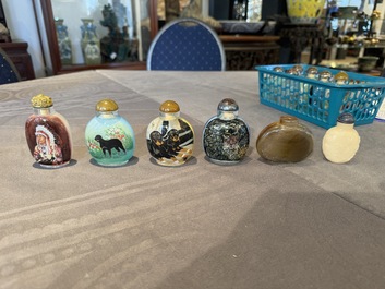 A Chinese gilt-lacquered wall display cabinet and a collection of various snuff bottles, stands and carvings, 20th C.
