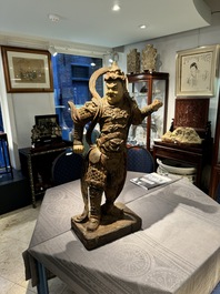 A large Chinese polychrome-lacquered wooden figure of a Guardian King, 18/19th C.