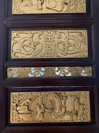 A Chinese four-part reticulated and partially gilt wooden folding screen, 19th C.