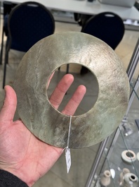 A Chinese celadon and russet jade 'bi' disc, Neolithic period
