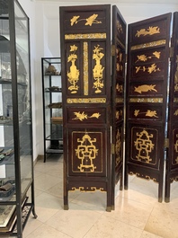 A Chinese four-part reticulated and partially gilt wooden folding screen, 19th C.