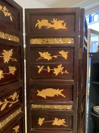 A Chinese four-part reticulated and partially gilt wooden folding screen, 19th C.