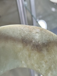 A Chinese celadon and russet jade 'bi' disc, Neolithic period