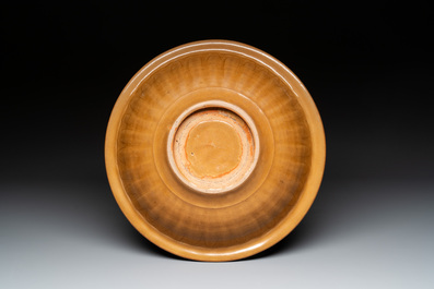 A Chinese incised brown-glazed Longquan dish with floral design, Ming