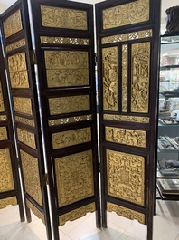 A Chinese four-part reticulated and partially gilt wooden folding screen, 19th C.