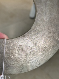 A Chinese celadon and russet jade 'bi' disc, Neolithic period