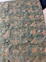 A Chinese green-ground embroidered silk panel with dragons among clouds, 18th C.