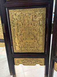 A Chinese four-part reticulated and partially gilt wooden folding screen, 19th C.
